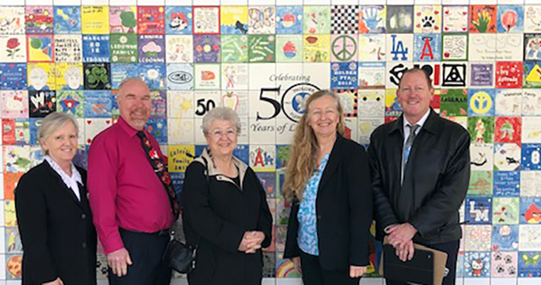 Board Members with Dr. Friedman at tile wall